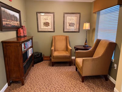 Cozy sitting area with chairs and artwork