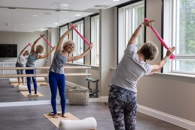 Residents participating in a stretching exercise class
