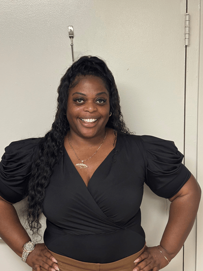 Smiling staff member posing in an interior space