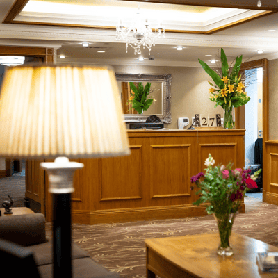 Welcoming lobby area with reception desk and flowers