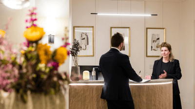 Reception area with staff assisting a visitor