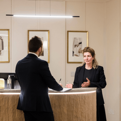 Staff member interacting with resident at reception