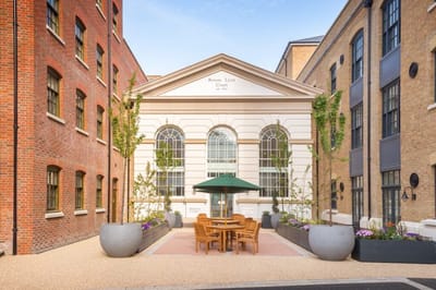 Exterior view of the Savoy House with outdoor seating.