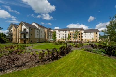 Exterior view of Savoy House with landscaped gardens.