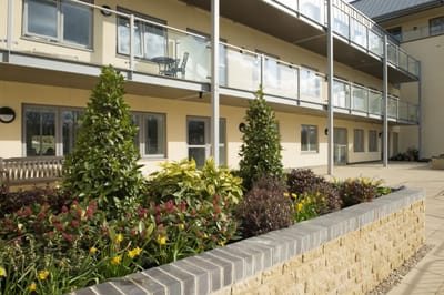 Outdoor space with plants and balconies.