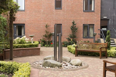 Court yard with benches and decorative landscaping.