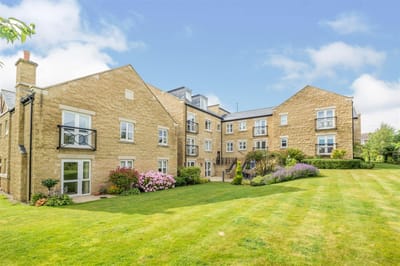 Exterior view of the facility with landscaped gardens