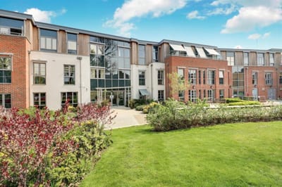 Exterior view of Savoy House with landscaped garden.