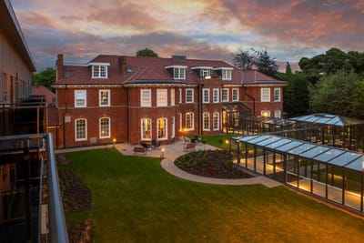 Exterior view of a retirement living facility at sunset.