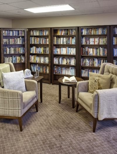Cozy reading area with bookshelves and chairs.