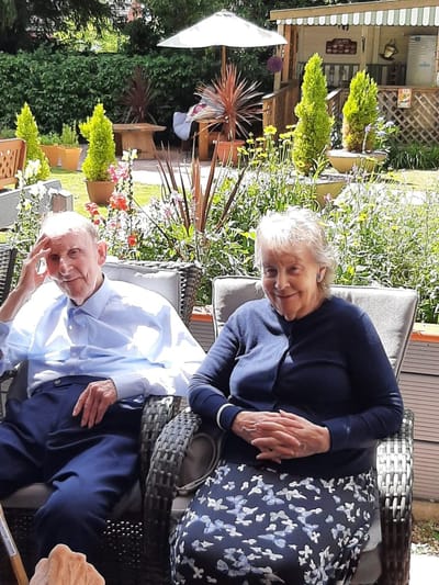 Residents enjoying time in a garden area.