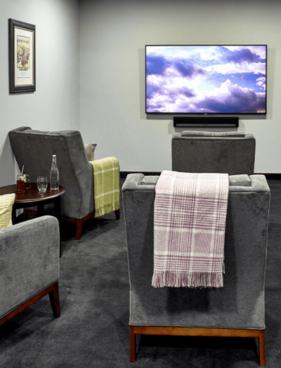 Cozy lounge area with comfortable chairs and a TV.