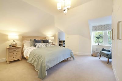 Cozy, well-lit bedroom with a bed and decor
