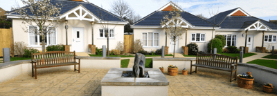 Outdoor seating area with landscaped gardens and cottages