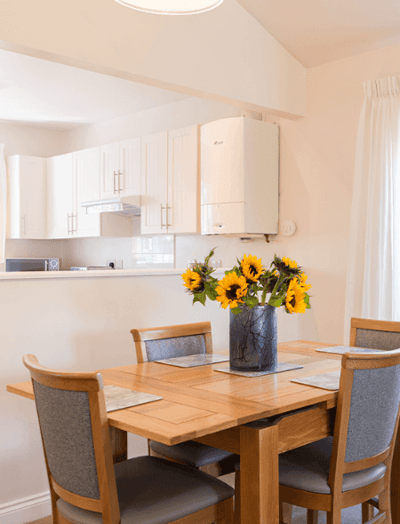 Dining table with sunflowers in a bright kitchen