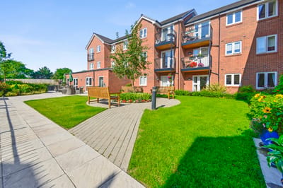 Outdoor garden area with benches and greenery