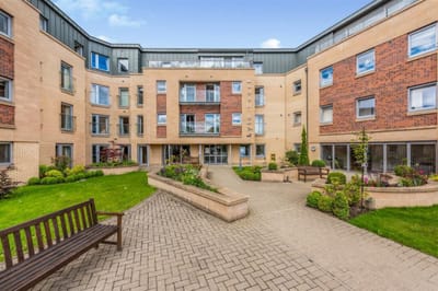 Exterior view of a retirement living facility with a garden