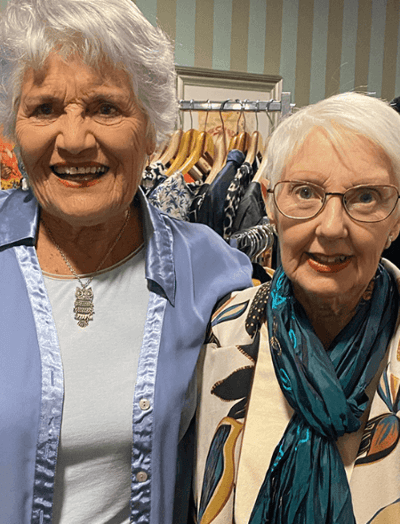 Two smiling senior women in a cozy setting.
