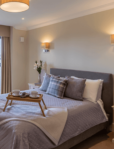 Cozy bedroom with stylish decor and tea setup