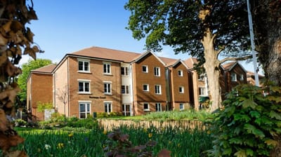 Exterior view of the retirement facility with gardens.