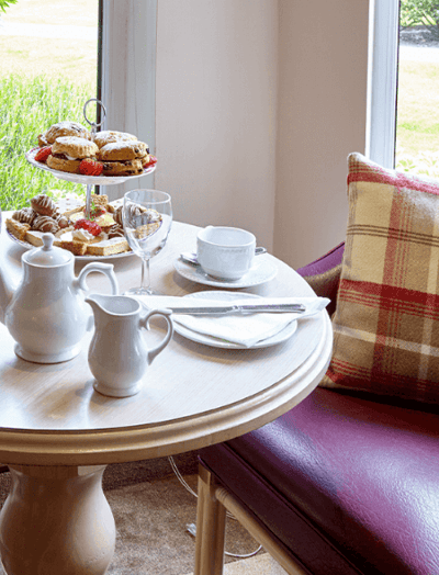 Cozy dining table set with tea and pastries.