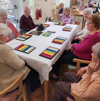 Seniors engaged in an activity around a table
