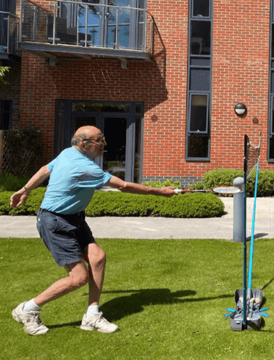 Resident participating in outdoor activity on the lawn.