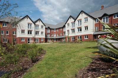 Exterior view of a retirement living facility and garden