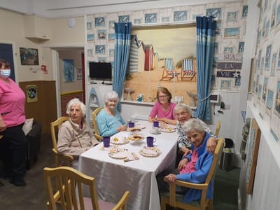 Residents enjoying snacks and drinks at a table