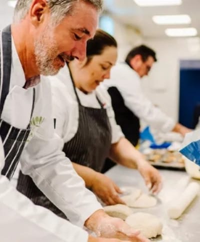 Staff preparing food in a kitchen setting.