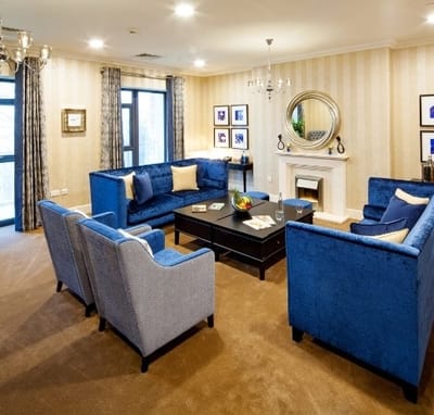 Comfortable common area with blue sofas and decor