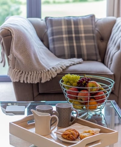 Cozy living area with fruit and pastries.