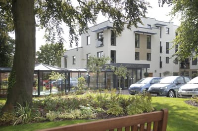 Exterior view of Savoy House with landscaped garden.