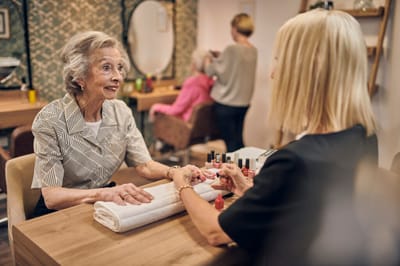 Senior woman enjoying a manicure at a salon