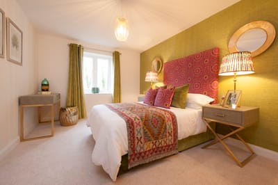 Cozy and well-decorated bedroom with colorful accents.