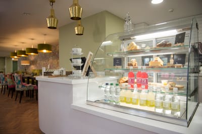 Food display in a dining area with refreshments and pastries.
