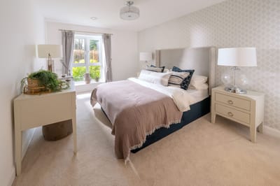 Modern bedroom with natural light and stylish decor.