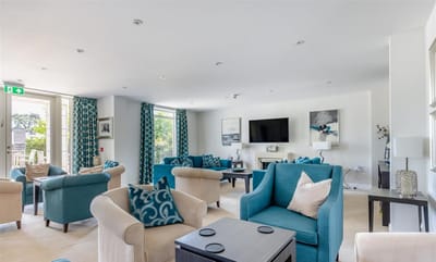Light-filled common area with seating and decor.