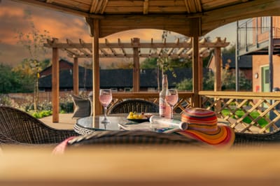 Gazebo with drinks and a hat during sunset