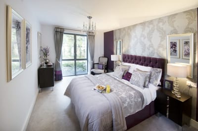 Cozy bedroom with elegant decor and natural light.
