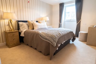 Cozy bedroom with modern decor and soft lighting.