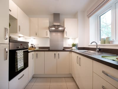 Modern kitchen with cabinets and appliances.