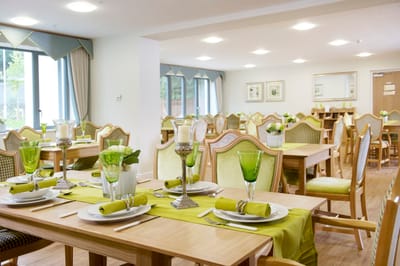 Dining area set up with green decor.