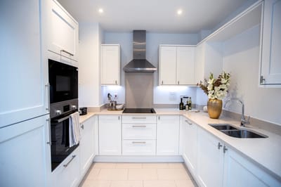 Modern kitchen with white cabinetry and decor