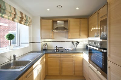 Bright, modern kitchen with wooden cabinets.