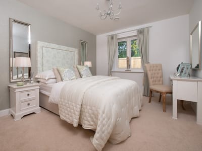 Cozy bedroom with a bed, chair, and stylish decor.