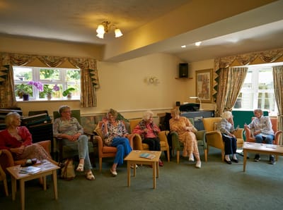 Residents engaging in conversation in a common area.