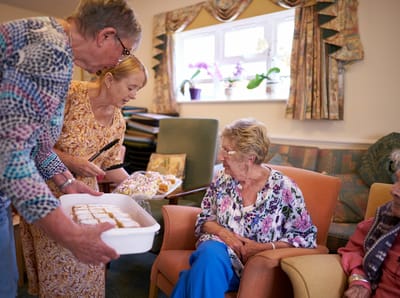 Residents enjoying snacks in a common area.