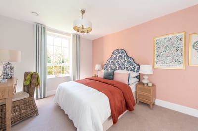 Cozy bedroom with a decorative headboard and natural light