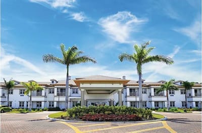 Exterior view of Beach House facility with palm trees